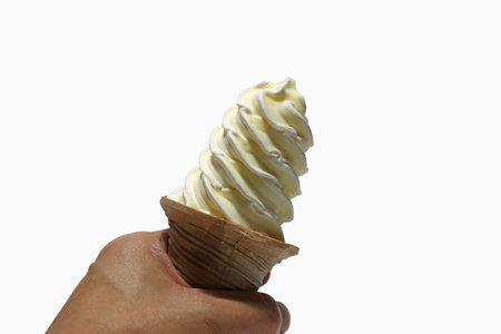 White ice cream spiral shape on the scoop in hand isolated on white background. Pure white vanilla...