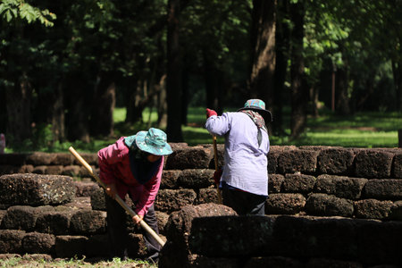 Sri Thep, Petchaboon, Thailand, Sep 06, 2018: Workers are clearing weeds grass for renovate area of...