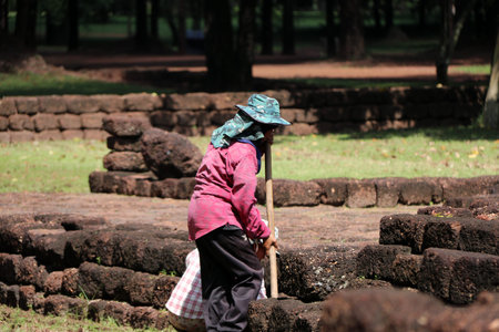 Sri Thep, Petchaboon, Thailand, Sep 06, 2018: Workers are clearing weeds grass for renovate area of archaeological site at Sri Thep ancient town.のeditorial素材