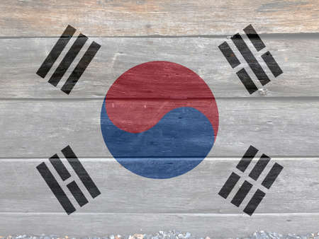 Flag of South Korea on wooden wall background. Grunge South Korean flag texture, the white color with Taegeuk and black trigrams.の写真素材