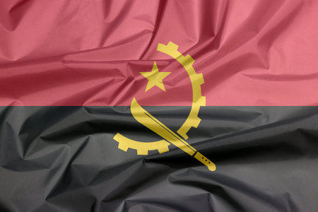 Fabric flag of Angola. Crease of Angola flag background, Two horizontal bands of red and black with...