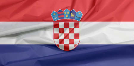 Fabric flag of Croatia. Crease of Croat flag background, red white and blue with the Coat of Arms of Croatia.の写真素材