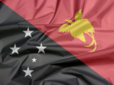 Fabric flag of Papua New Guinea. Crease of Papua New flag background, triangle is red with the...
