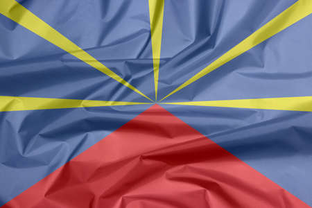 Fabric flag of reunion. Crease of reunion flag background, red yellow and blue color.の写真素材