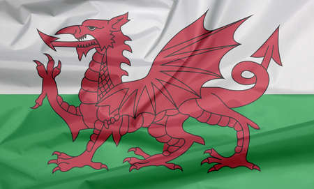 Fabric flag of Wales. Crease of Wales flag background, consists of a red dragon passant on a green and white field.の写真素材