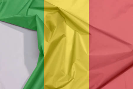 Mali fabric flag crepe and crease with white space, A vertical tricolor of green gold and red.の写真素材