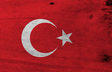 Flag of Turkey on wooden plate background. Grunge Turkey flag texture, a red field with a white star and crescent slightly left of center.の写真素材