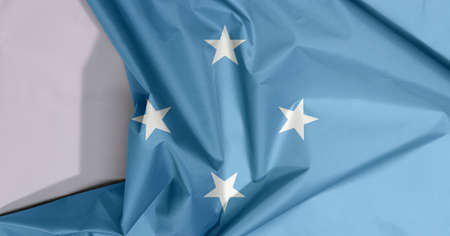 Federated States of Micronesia fabric flag crepe and crease with white space, A light blue field with four stars arranged in the diamond pattern.の写真素材