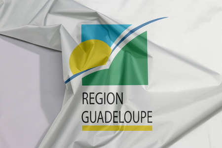 Guadeloupe Region fabric flag crepe and crease with white space, A circle of twelve five-pointed yellow stars on a blue field.の写真素材
