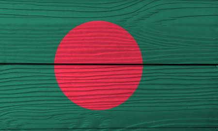 Flag of Bangladesh on wooden wall background. Grunge Bangladesh flag texture, a red disc on green field.の写真素材