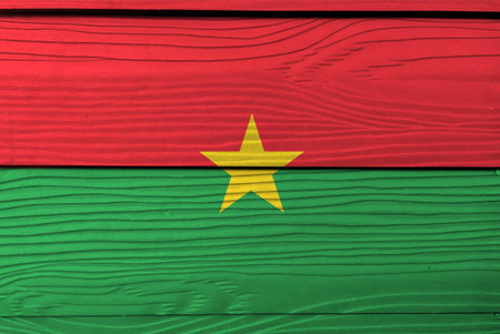 Flag of Burkina Faso on wooden wall background. Grunge Burkina Faso flag texture, red and green in yellow star.の写真素材