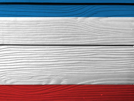 Flag of Crimea on wooden wall background. Grunge Crimea flag texture, a blue white and red triband.の写真素材