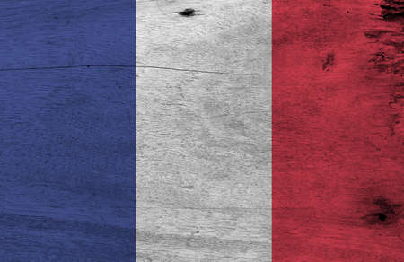 Flag of France on wooden plate background. Grunge French flag texture, it is a vertical tricolor of blue white and red.の写真素材