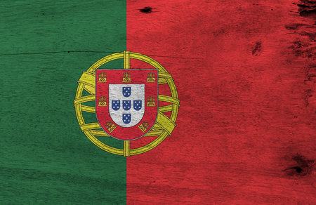 Flag of Portugal on wooden plate background. Grunge Portuguese flag texture, 2:3 vertically striped bicolor of green and red, with coat of arms of Portugal.の写真素材
