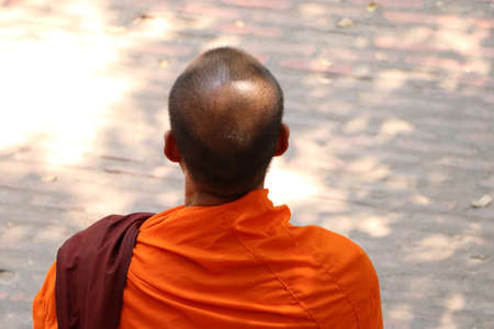 Head and beside of Asian monks or buddhist monks which wears a dress in yellow or orange.の写真素材