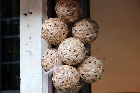 Rattan ball hanging in a bunch, it is a local sport of Southeast Asian people. In Myanmar called âchinloneâ and in Thailand called âTakrawâ.の写真素材