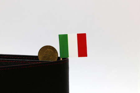 One coin of Italy Lire money and mini Italy flag stick on the black wallet with white background. REPVBBLICA ITALIANA, Lire Italia money the concept of finance.の写真素材
