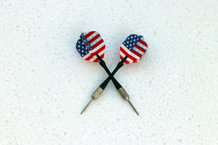 Two black dart with United state of America flag of the wing on the white foam board.