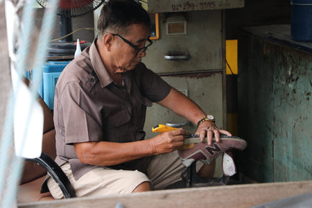 Lat Lum Kaeo, Pathum Thani, Thailand, Sep 9, 2019 : An old man who has a professional in shoes...