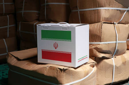 Iran flag on white box with barcode and the color of nation flag on the stack of brown box. The concept of export trading from Iran, paper packaging for put products.の写真素材
