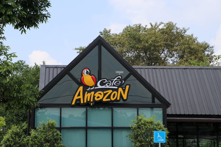 Muang, Pathum Thani, Thailand - Oct 7, 2019 : Logo of Cafe Amazon coffee shop with nature...