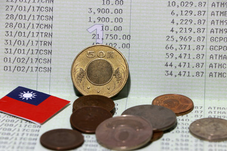 Heap of Taiwan dollars coin money and mini Taiwan flag on the book bank. Concept of Saving money or...