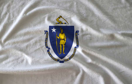 Towel fabric pattern flag of Massachusetts, Crease of Massachusetts flag background. The states of America, coat of arms centered on a white field.の写真素材