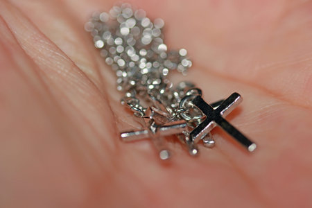 Metal crucifix bracelet on the palms. concept of faith and belief.の写真素材