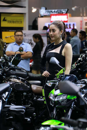 Nonthaburi, Thailand, Dec 06, 2019 : Beautiful Asian Pretty with Kawasaki motorbike, popular marketing for making motorcycle booth interest at Thailand International Motor Expo 2019.のeditorial素材