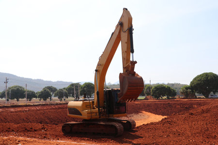 Yellow Alloy Excavator Truck Car Vehicles on the lateritic soil which is the area for digging.