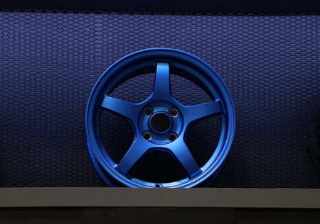 Blue Alloy Wheel of car on the shelf. Alloy wheels are wheels that are made from an alloy of...