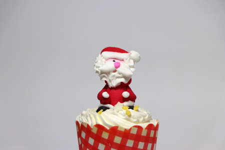 Christmas cupcakes decorated with Santa Claus on white background.の写真素材
