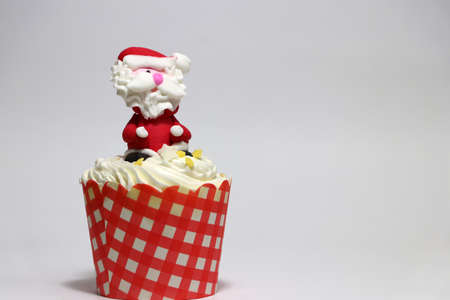 Christmas cupcakes decorated with Santa Claus on white background.の写真素材