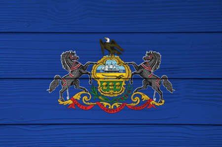 Pennsylvania flag color painted on Fiber cement sheet wall background. Coat of arms of Pennsylvania on blue field. The state of America.の写真素材