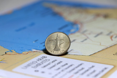 One coin of United Arab Emirates one dirham money on reverse put on UAE map. Concept of finance or...