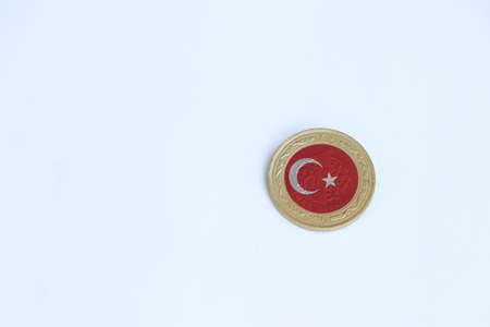 Turkey flag on the coin of one Turk Lirasi or Turkish lira money on the white background. Concept of finance or currency.の写真素材
