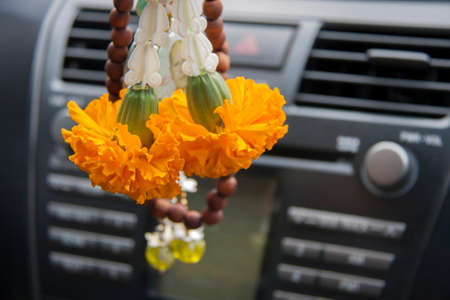 flower garland contains the yellow Marigold and crown flower hanging in the car. Fortunately for safe travel and good luck.の写真素材