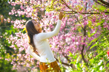 Happy young woman on flowers garden