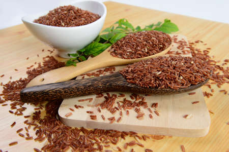 Set of rice collection on ladle on wood texture background.の写真素材