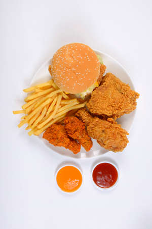 Fast food set containing burgers, fried chicken and french fries isolated on white background.の写真素材