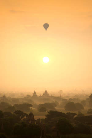 Sunrise scene hot air balloons fly over pagoda ancient city field in Bagan Myanmar.の写真素材