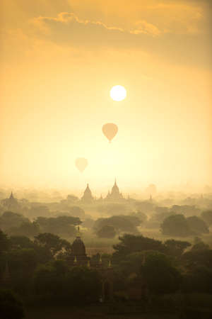 Sunrise scene hot air balloons fly over pagoda ancient city field in Bagan Myanmar.の写真素材
