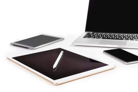 Office table with laptop computer, digital tablet, smartphone, pencil and mouse on isolated pure...