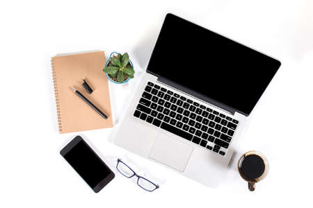 Office table with laptop computer, smartphone, pen, notebook and coffee on isolated pure white background / Laptop and tablet mockup concept. (Selective Focus)の写真素材