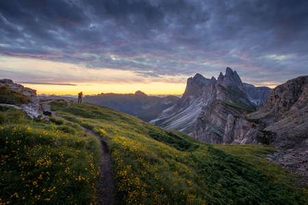 Amazing landscapes view of green mountain with gold sky on sunrise morning from Dolomites, Italy.の写真素材