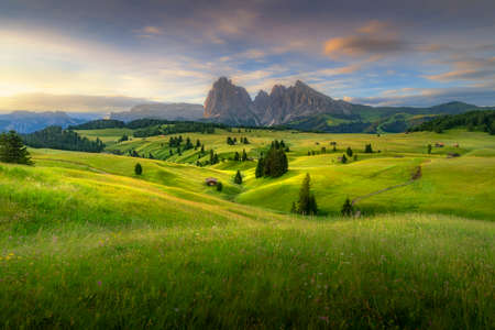 Amazing landscapes view of green hills with summer blue sky on sunrise from Seiser Alm Dolomites, Italy.の写真素材