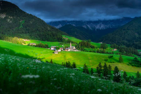 Amazing landscapes view of green hill and mountain with blue sky on sunset from Dolomites, Italy.の写真素材