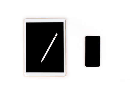 Office table with digital tablet, smartphone and pencil on isolated pure white background / Laptop and tablet mockup concept. (Selective Focus)の写真素材