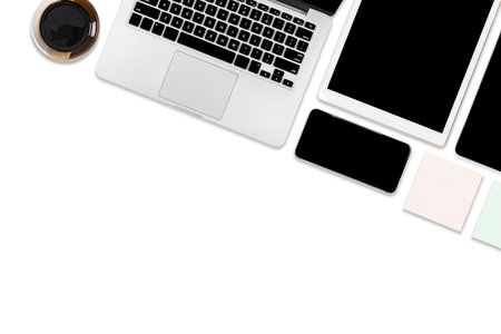 Flat lay photo of office table with laptop computer, digital tablet, mobile phone and accessories....