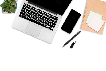 Flat lay photo of office table with laptop computer, digital tablet, mobile phone and accessories....